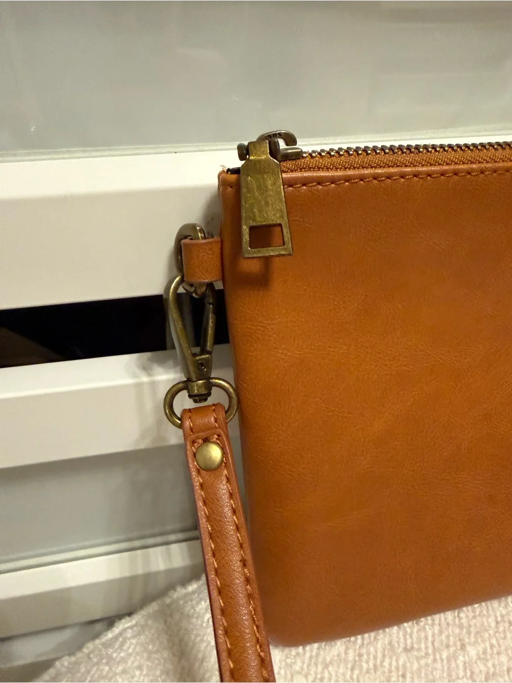 Milkmaid Goods camel colored wristlet clutch